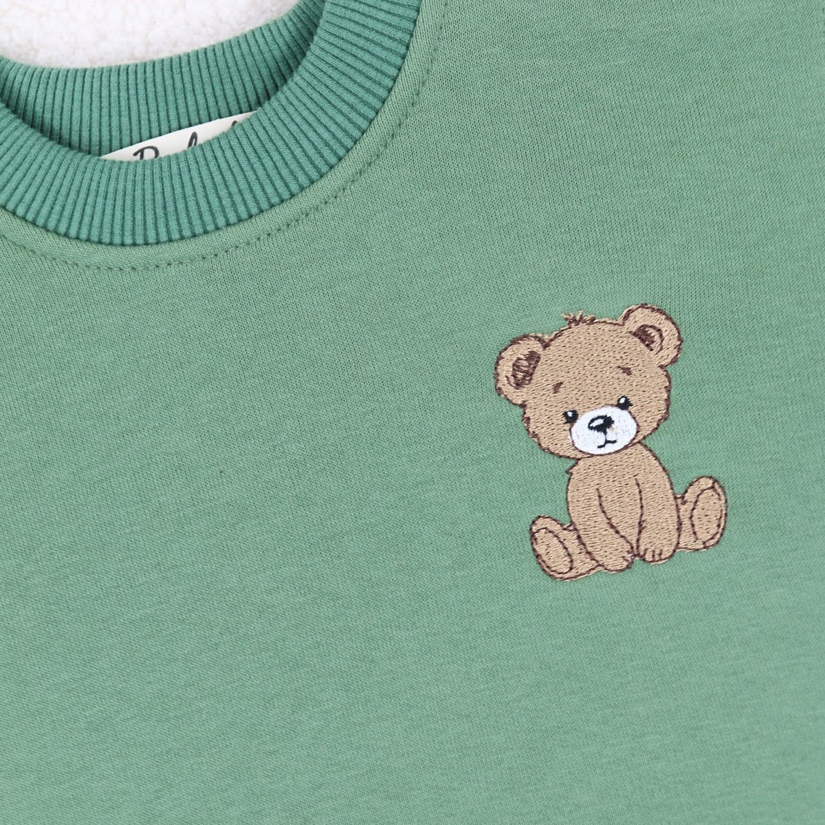 Embroidered teddy bear detail on Babyli sage green baby tracksuit