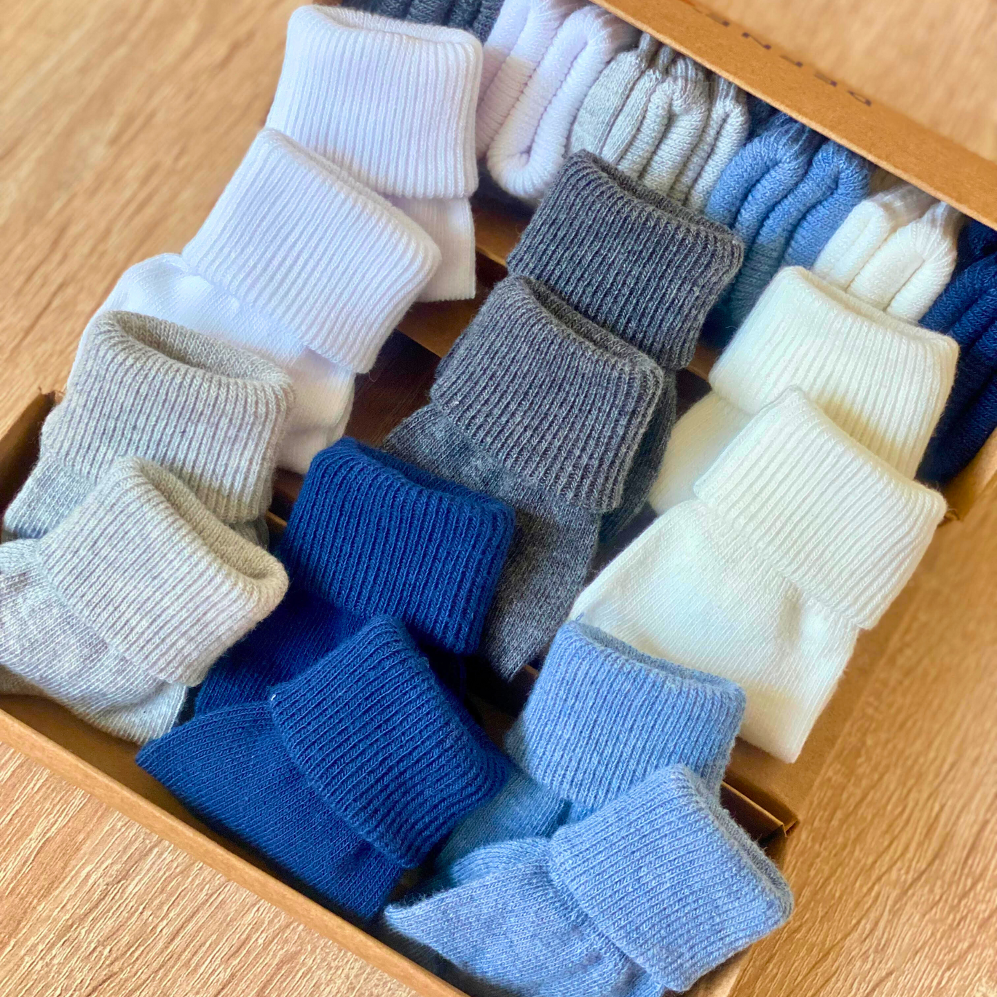 Soft ribbed baby socks in blue and neutral colours