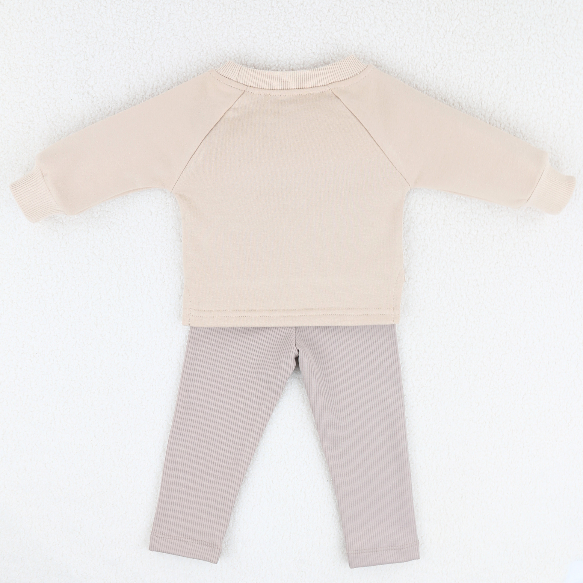 Back view of beige baby sweatshirt and ribbed leggings set