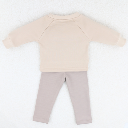 Back view of beige baby sweatshirt and ribbed leggings set