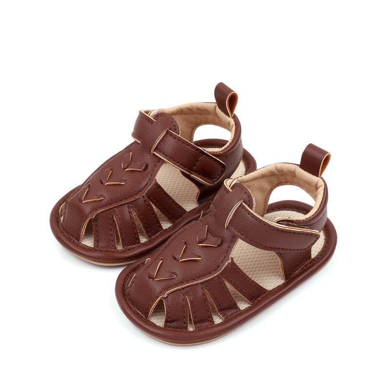 Baby boys brown leather look sandals pair showing arrow stitch detail and cut-out design by Babyli, soft sole boutique baby shoes UK