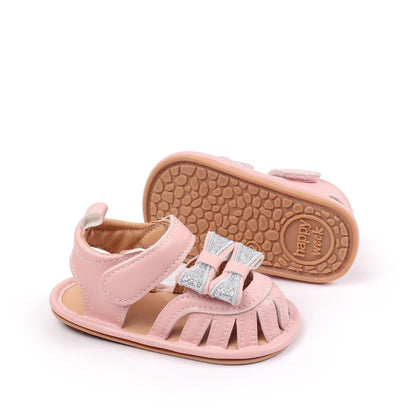 Baby girls pink glitter bow sandal showing non-slip Happy Week TPR sole and side view by Babyli, soft sole baby shoes UK