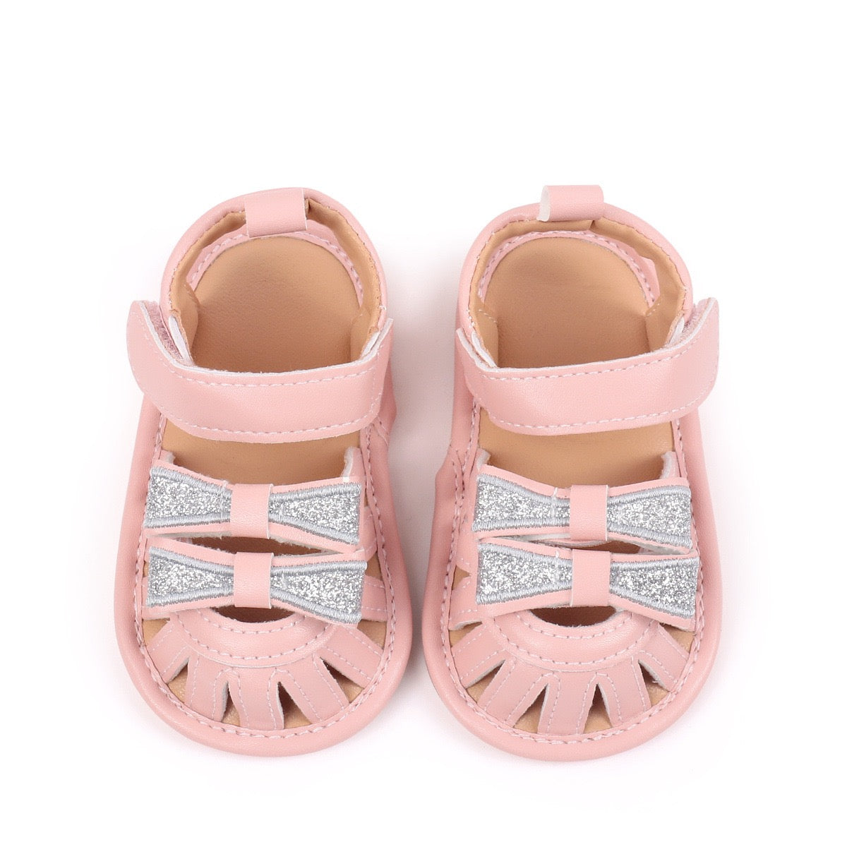 Baby girls pink sandals with double silver glitter bow detail top view showing pair by Babyli, boutique soft sole baby shoes UK