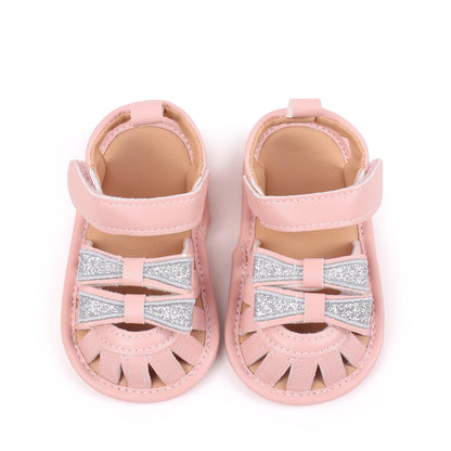Baby girls pink sandals with double silver glitter bow detail top view showing pair by Babyli, boutique soft sole baby shoes UK