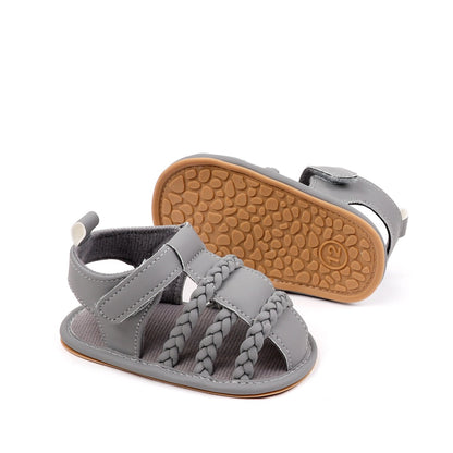 Baby unisex grey braided sandal showing non-slip TPR pebble sole and side view with velcro strap by Babyli, soft sole baby shoes UK