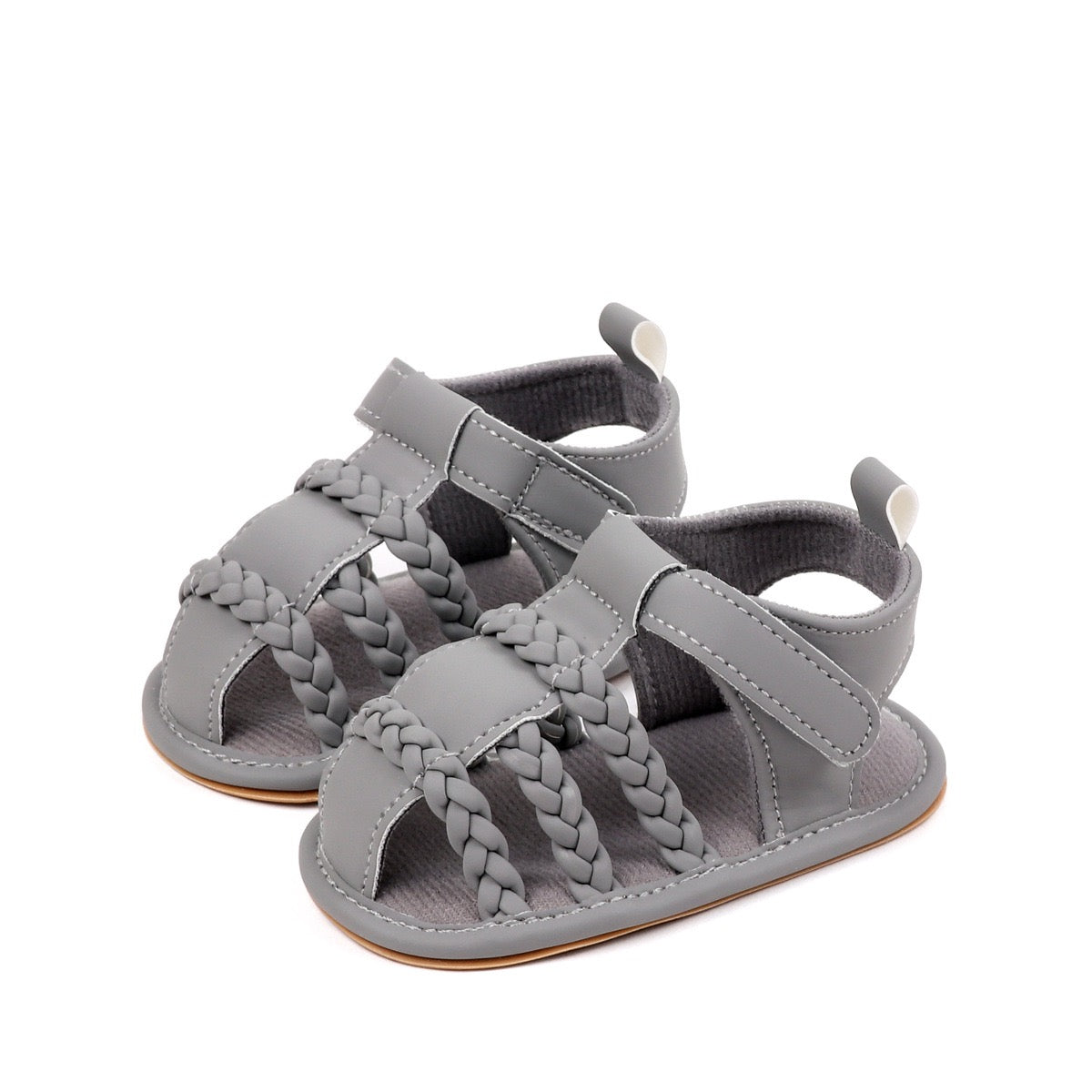 Baby unisex grey sandals pair from low front angle showing triple braided cross strap and velcro closure by Babyli, soft sole baby shoes UK