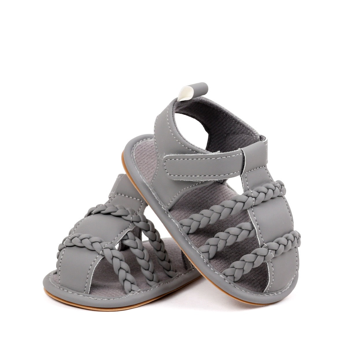 Baby unisex grey sandals pair showing triple braided strap detail and rubber sole from diagonal angle by Babyli, soft sole baby shoes UK