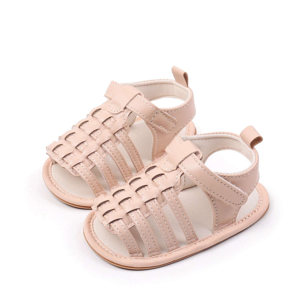 Baby unisex nude woven leather look sandals pair from diagonal angle showing intricate woven upper and open toe design by Babyli, soft sole baby shoes UK