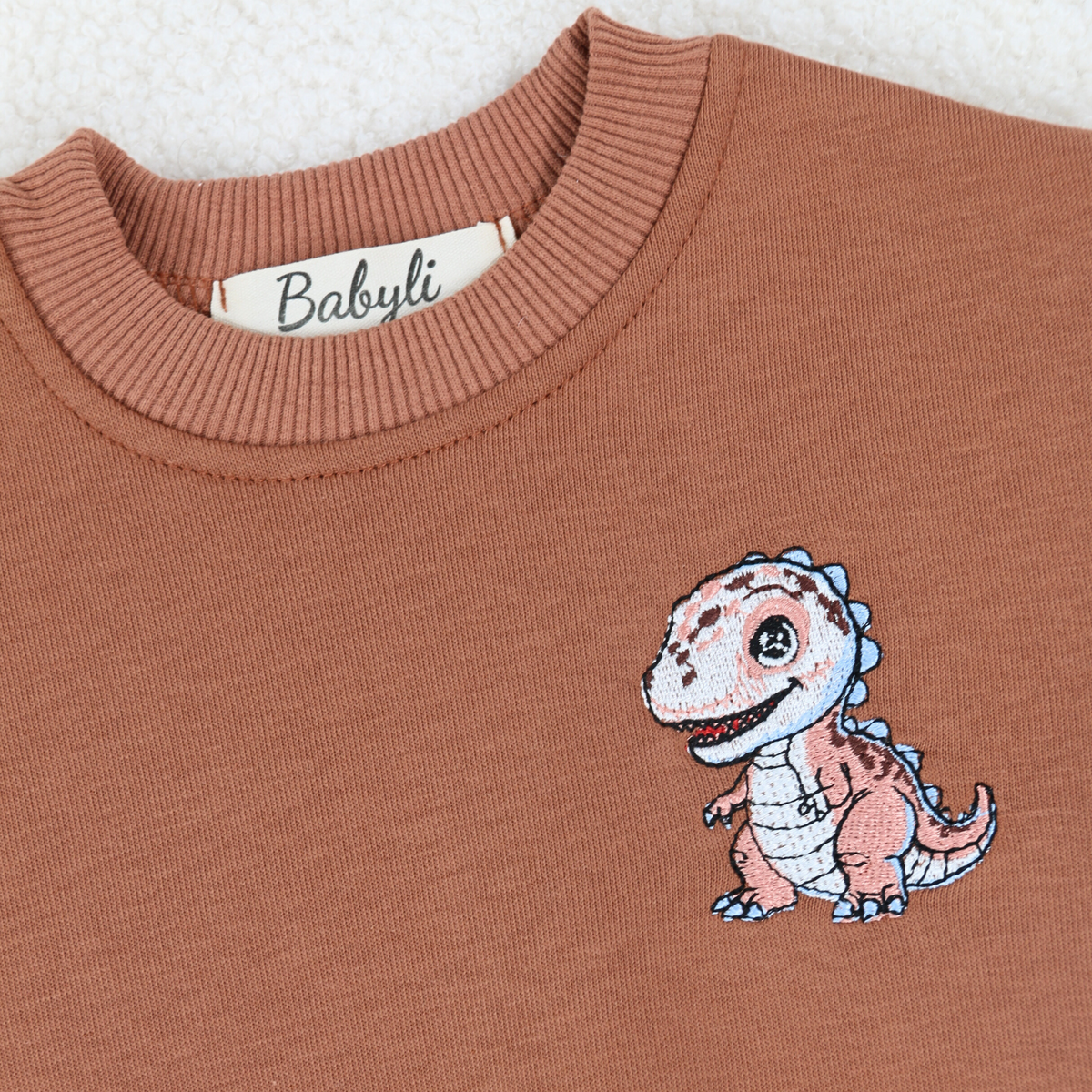 Embroidered dinosaur detail on Babyli brown baby tracksuit