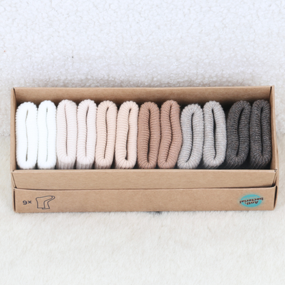 6-pack of newborn baby socks in taupe, grey and neutral tones laid out in their gift box