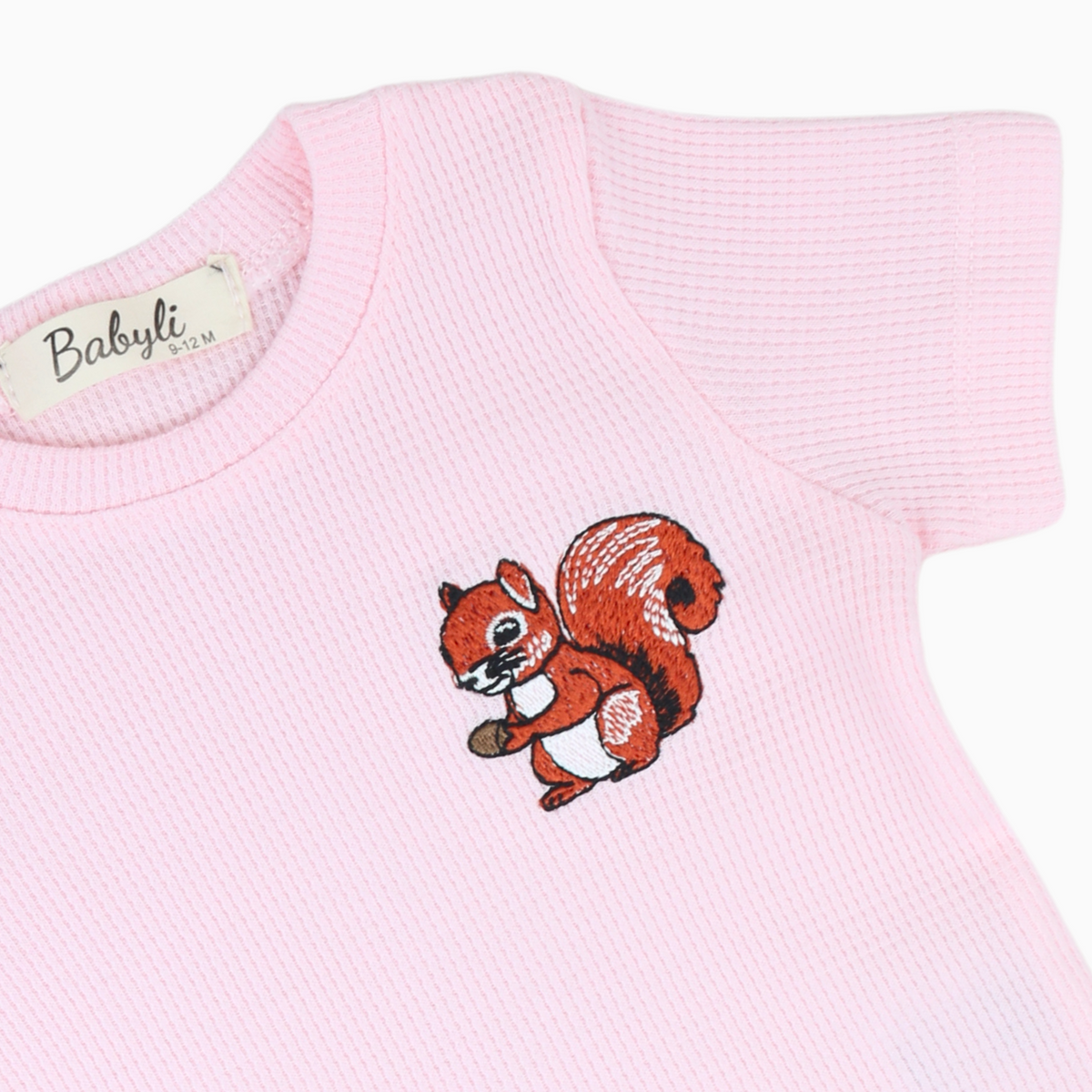 Close-up of Babyli pink squirrel embroidery on baby and toddler t-shirt and shorts set