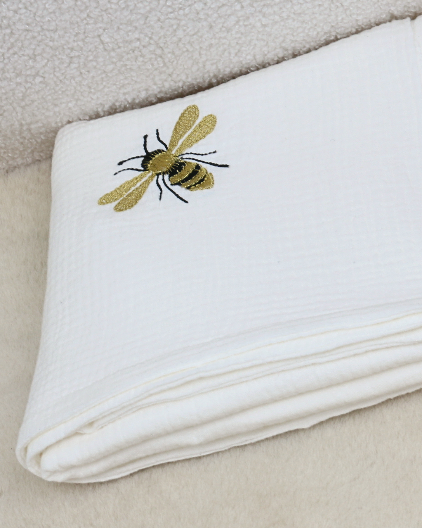White muslin baby blanket with embroidered bees