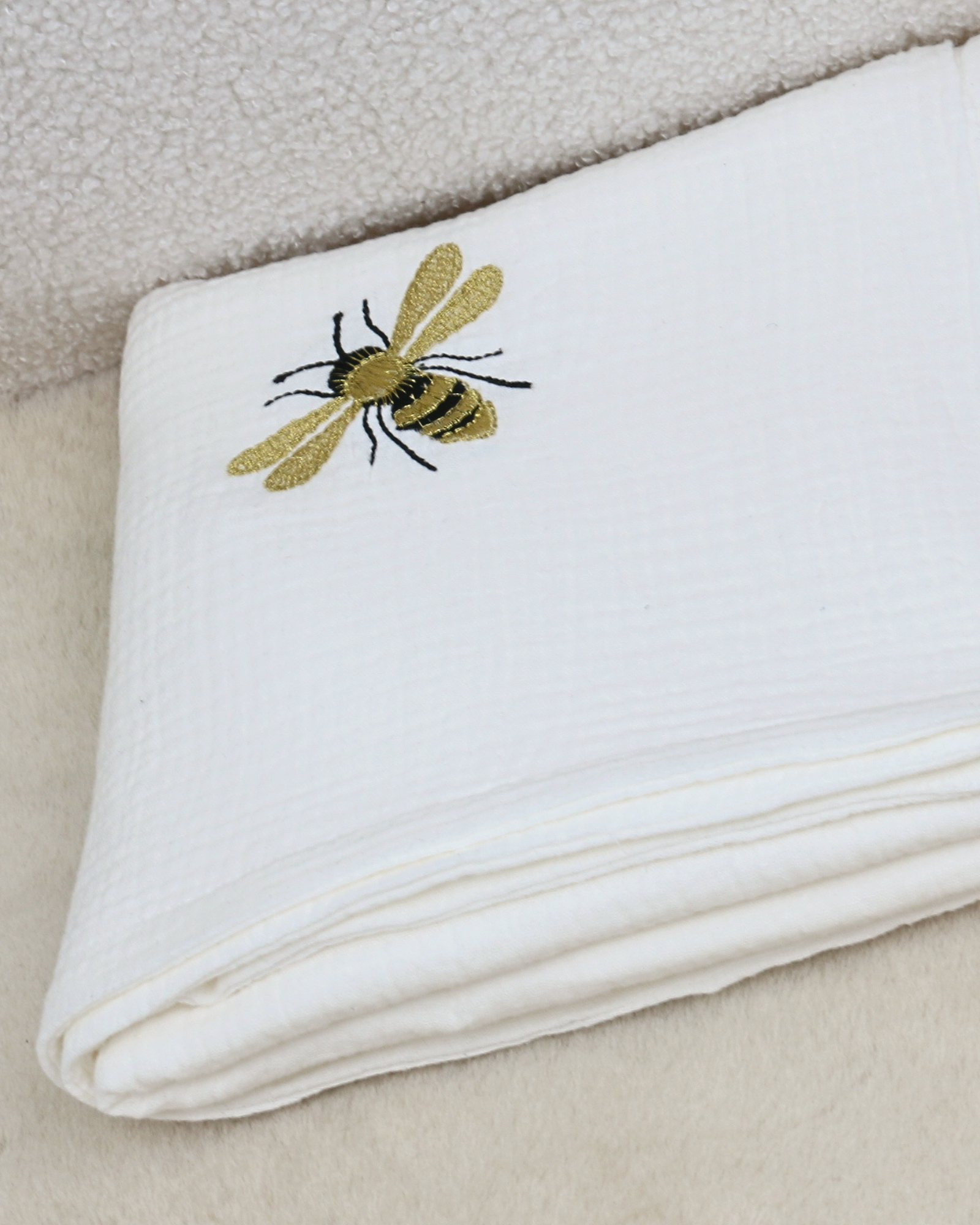 White muslin baby blanket with embroidered bees