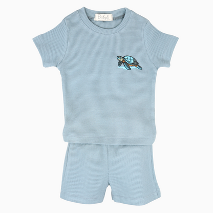 Light blue baby t-shirt and shorts set with embroidered turtle detail.