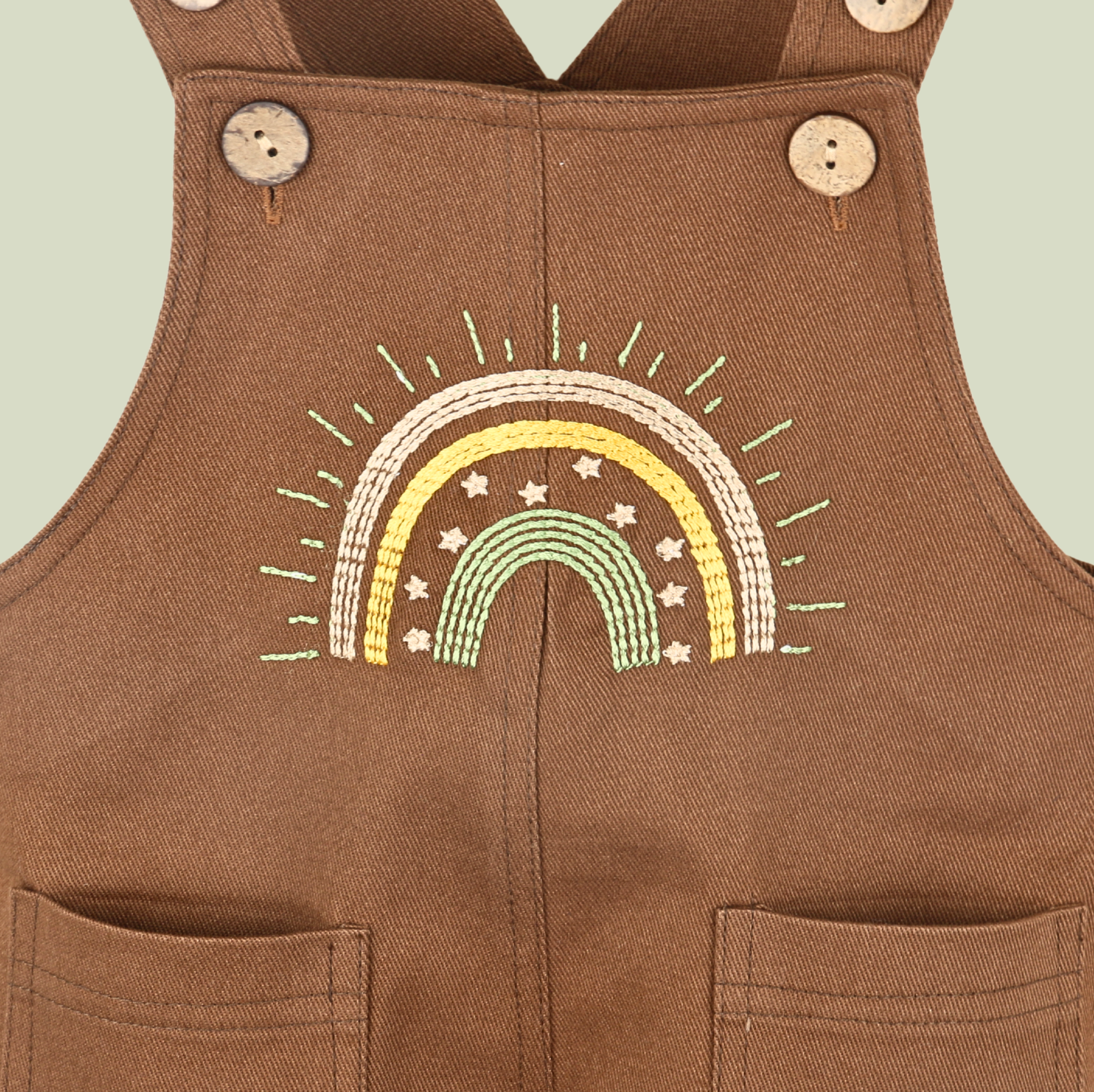 Brown baby dungarees with rainbow embroidery detail.
