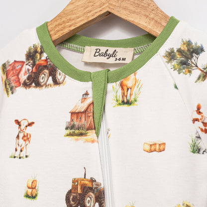 Close-up of Babyli Farmyard Double Zip Baby Sleepsuit showing neckline, zip fastening and farm animal print details