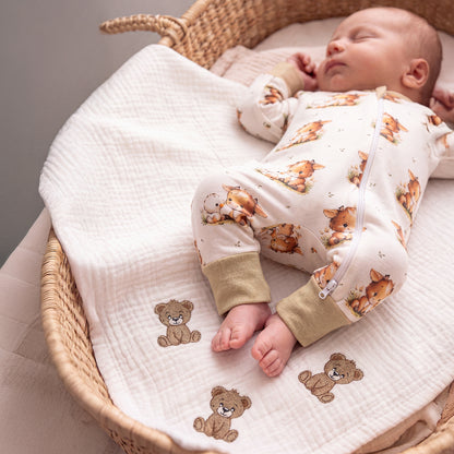 Sleeping baby wearing Babyli Highland Cow Double Zip Baby Sleepsuit featuring a Highland cow print and two-way zip fastening