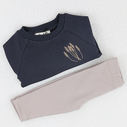 Folded navy baby sweatshirt with matching ribbed leggings