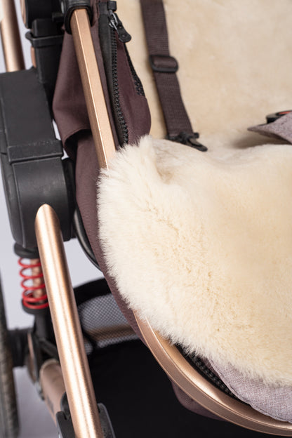 Cosy genuine sheepskin baby pram liner with soft wool finish.